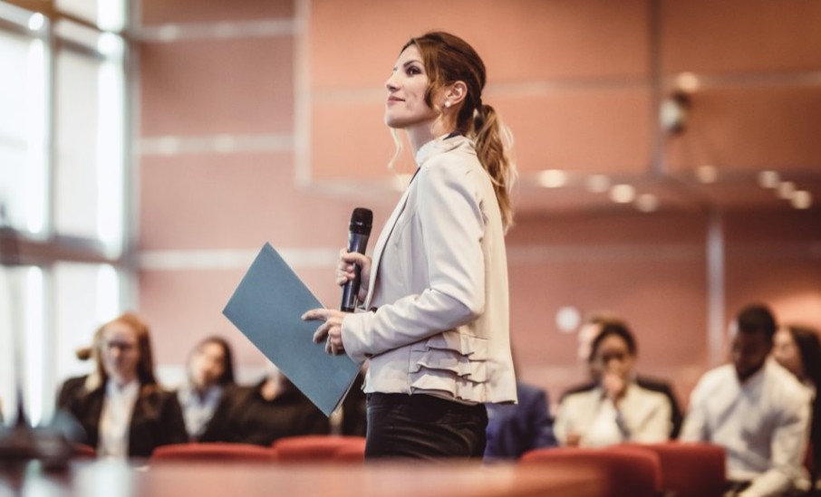 Woman presenting mic in hand
